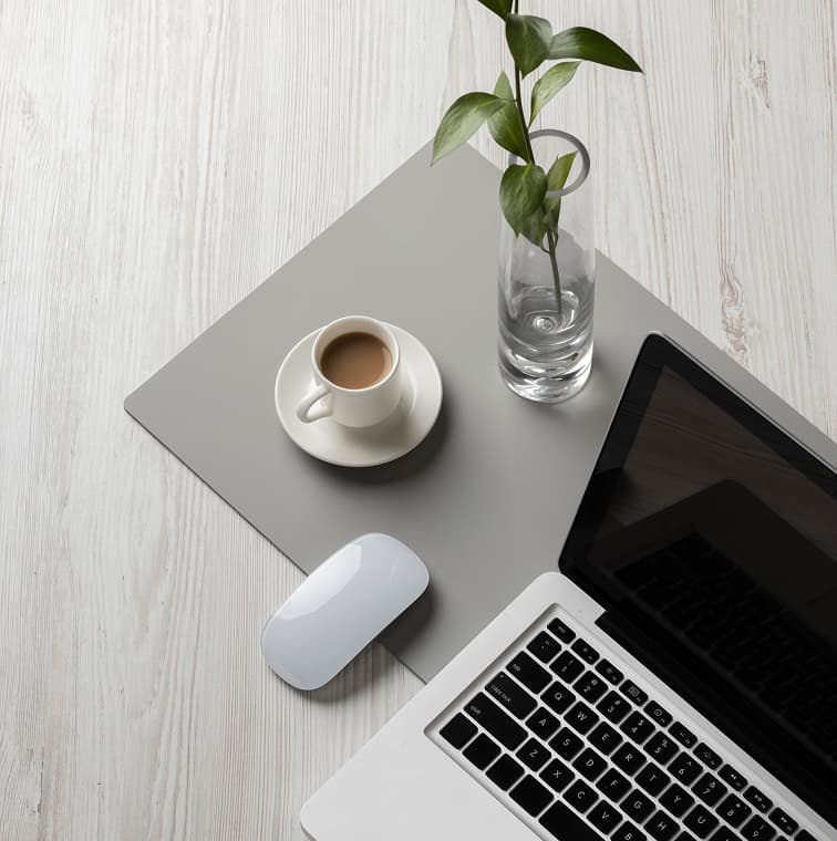 Workspace with coffee, plant, laptop and accessories